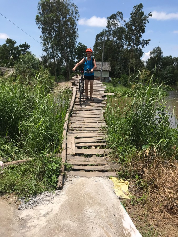 Mann med sykkel på en bro